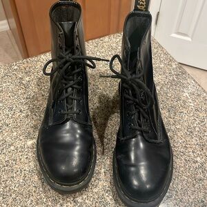 Black leather Dr. Martens boots.